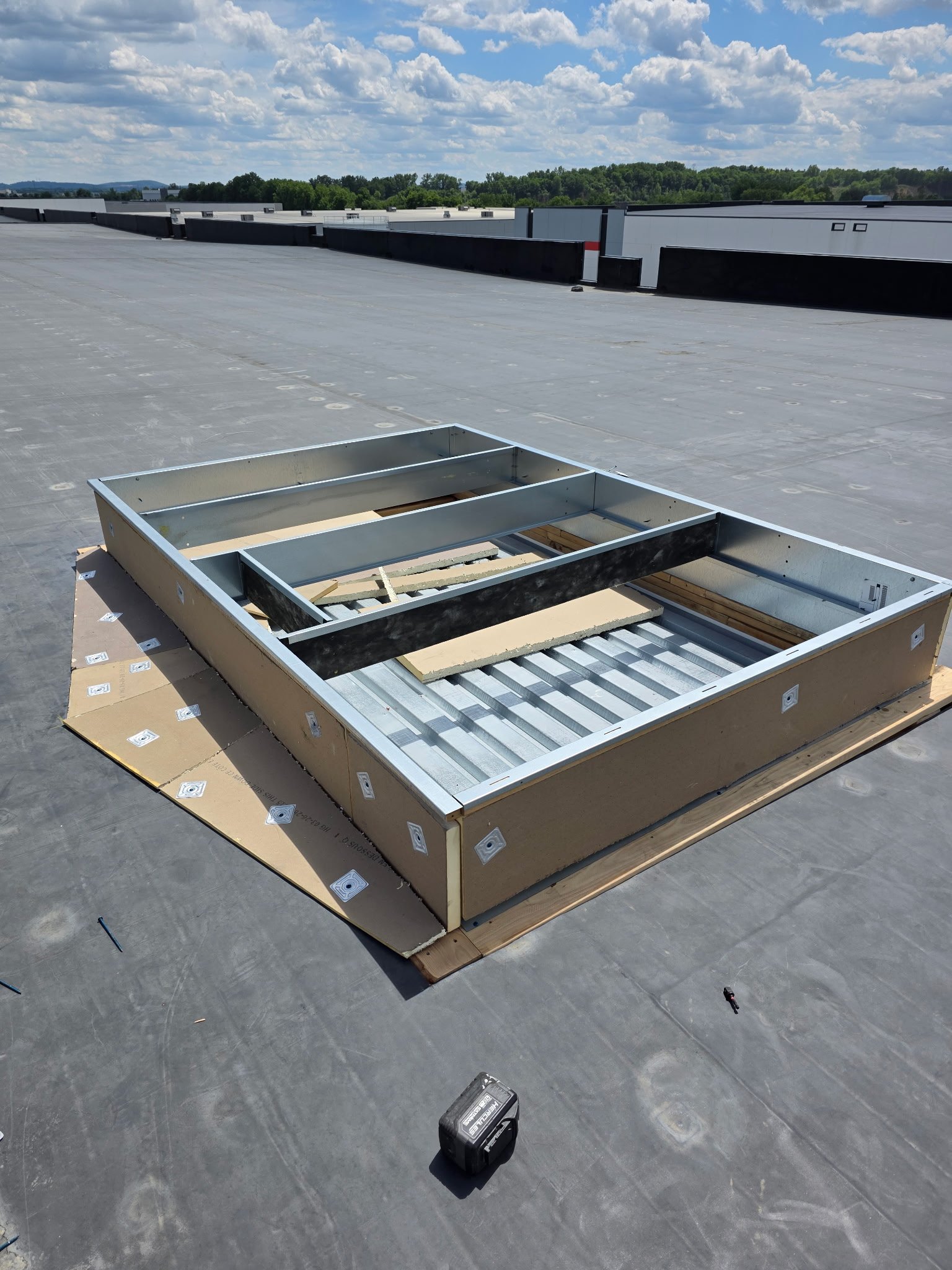 Reyes Roofing crew inspecting commercial roof seams