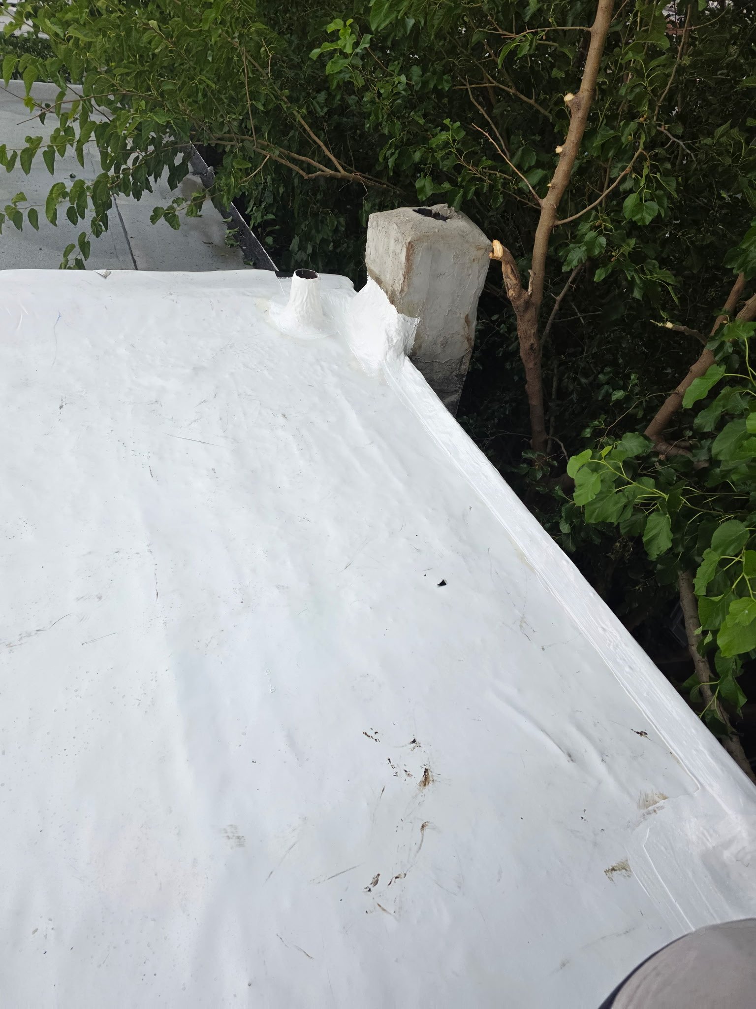 Roof coating application by Reyes Roofing crew